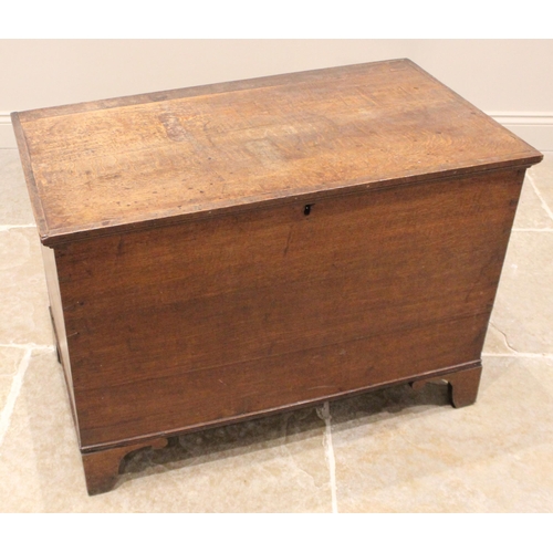 980 - A 19th century oak blanket chest, the hinged cover opening to a vacant interior, upon bracket feet, ... 