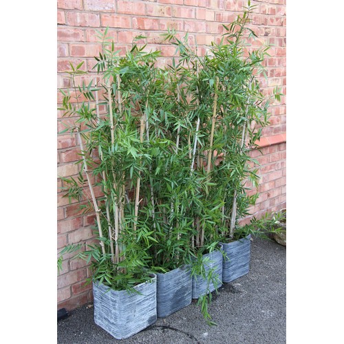 1067 - Four faux bamboo plants in decorative pots, each approximately 1.7m high (4)