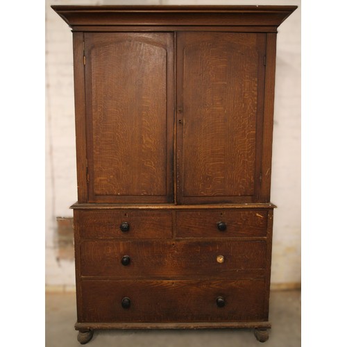 977 - A Victorian scumbled pine housekeepers cupboard, the cavetto cornice over a pair of cupboard doors o... 