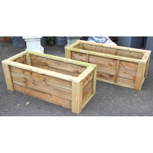 1125 - A pair of wooden planters, each of rectangular slatted form, 47cm x 128cm x 50cm (2)