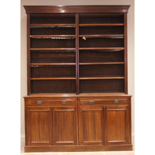 968 - A late Victorian walnut library bookcase, the moulded cornice over twin open sections and ten adjust... 