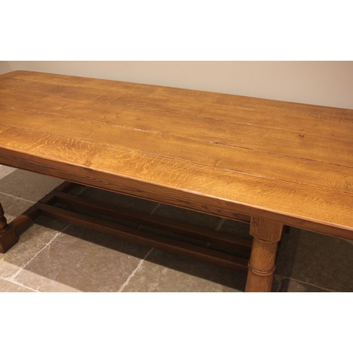 1048 - A medium oak refectory table in the 17th century style, late 20th/early 21st century, the cleated pl... 