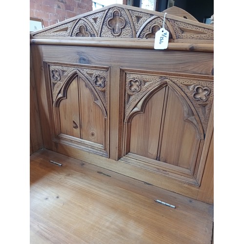 992 - A Gothic influence pine box settle, late 20th century, the architectural back rest with quatrefoil m... 