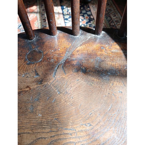 944 - A 19th century ash and elm Windsor farmhouse chair, impressed 'T.H' to the seat, the hoop back over ... 