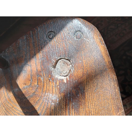 944 - A 19th century ash and elm Windsor farmhouse chair, impressed 'T.H' to the seat, the hoop back over ... 