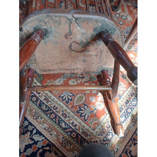 944 - A 19th century ash and elm Windsor farmhouse chair, impressed 'T.H' to the seat, the hoop back over ... 