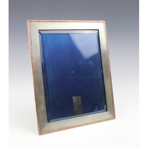 1 - A George V silver photograph frame, possibly Colen Hewer Cheshire, Chester 1914, the rectangular eng... 