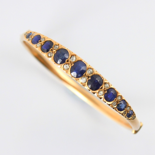 100 - A late 19th century untested sapphire and diamond bangle, the graduated untested sapphire (majority ... 