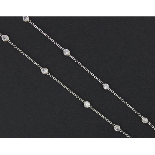 103 - An early 20th century style diamond set chain, the nineteen brilliant cut diamonds spectacle set in ... 