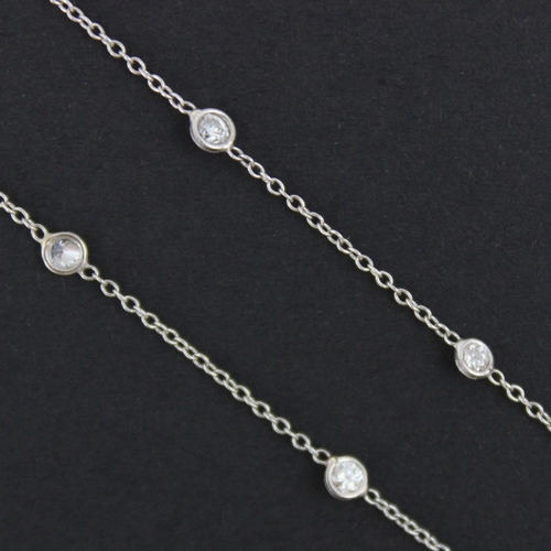 103 - An early 20th century style diamond set chain, the nineteen brilliant cut diamonds spectacle set in ... 