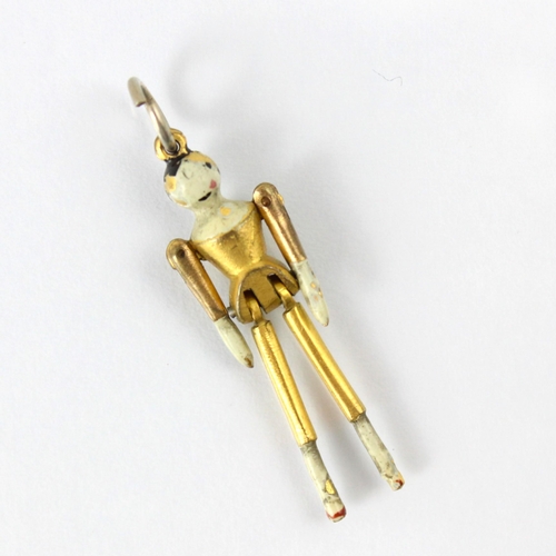 108 - A 19th century style gold plated peg doll charm, the articulated limbs with enamel detail and associ... 