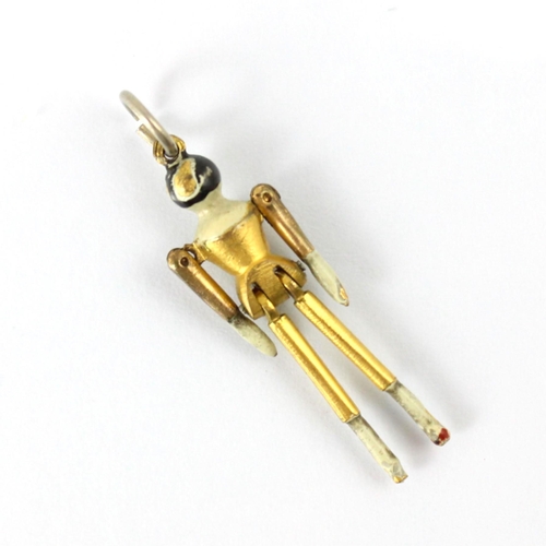 108 - A 19th century style gold plated peg doll charm, the articulated limbs with enamel detail and associ... 