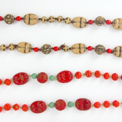 116 - An early 20th century Max Neiger necklace, the twenty 'scarab beetle' designed red beads with spheri... 