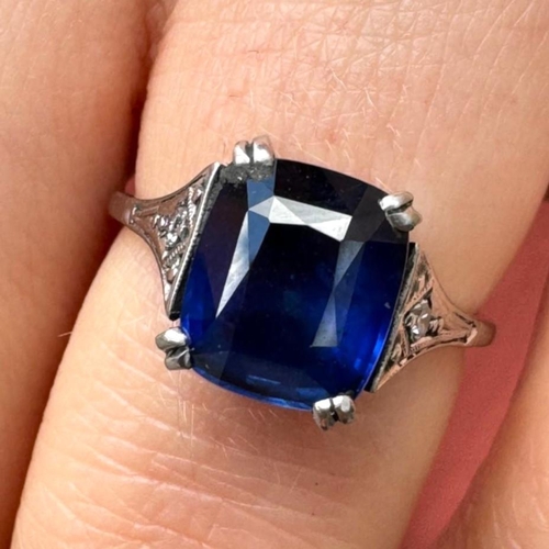 121 - An early 20th century Art Deco sapphire and diamond ring, the central cushion cut sapphire with doub... 