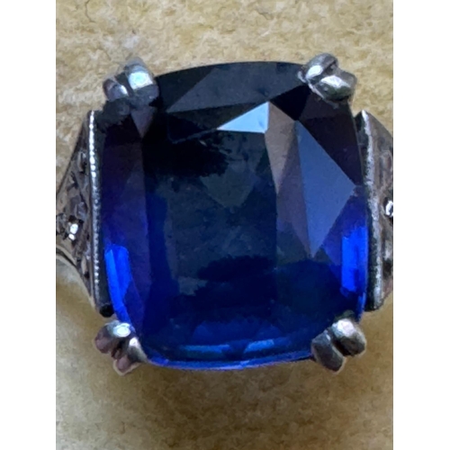 121 - An early 20th century Art Deco sapphire and diamond ring, the central cushion cut sapphire with doub... 