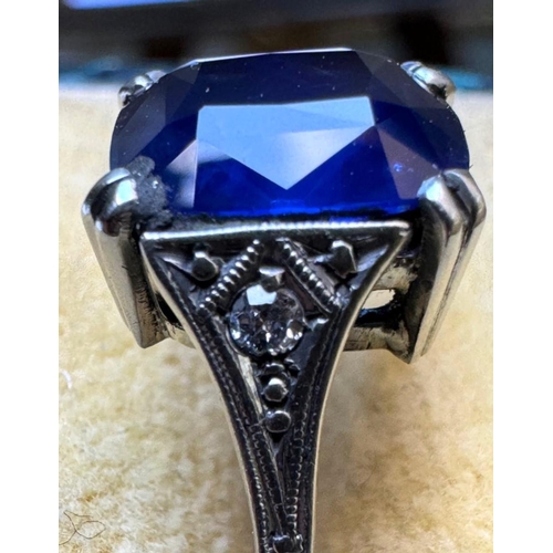 121 - An early 20th century Art Deco sapphire and diamond ring, the central cushion cut sapphire with doub... 