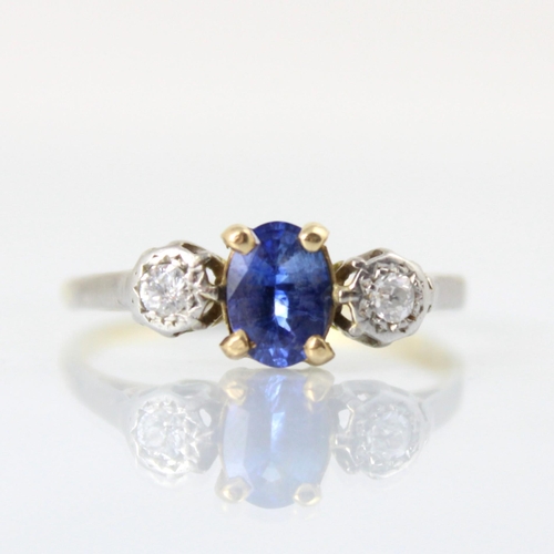 123 - An early 20th century untested sapphire and diamond three stone ring, the central oval cut untested ... 