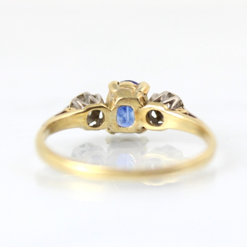 123 - An early 20th century untested sapphire and diamond three stone ring, the central oval cut untested ... 