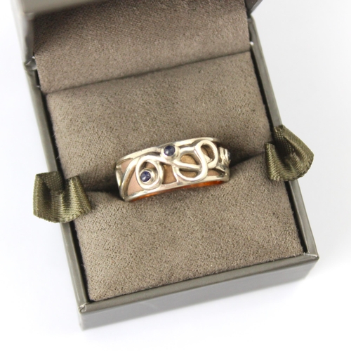 125 - A Clogau yellow metal and silver dress ring, the ‘Tree of life’ style ring with three blue stone cab... 