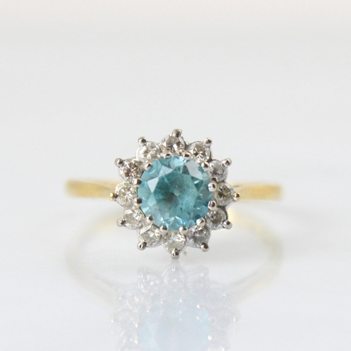 126 - An Edwardian style 18ct yellow gold blue zircon and diamond cluster ring, the round cut blue zircon ... 