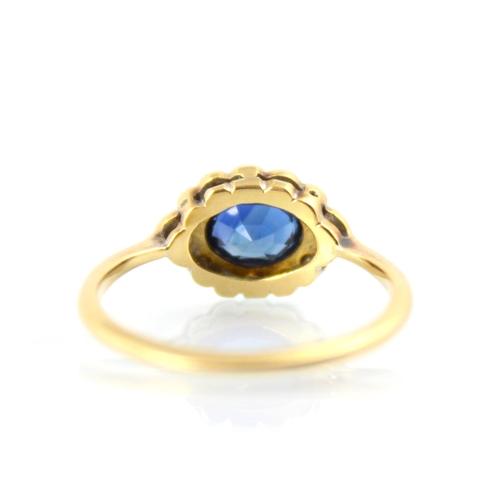 128 - An early 20th century untested sapphire and diamond set stylised cluster ring, the central untested ... 