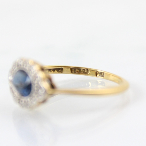 128 - An early 20th century untested sapphire and diamond set stylised cluster ring, the central untested ... 