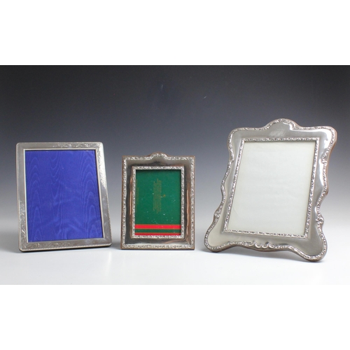 19 - A George V silver photograph frame, J & R Griffin, Chester 1912, the shaped rectangular frame with w... 