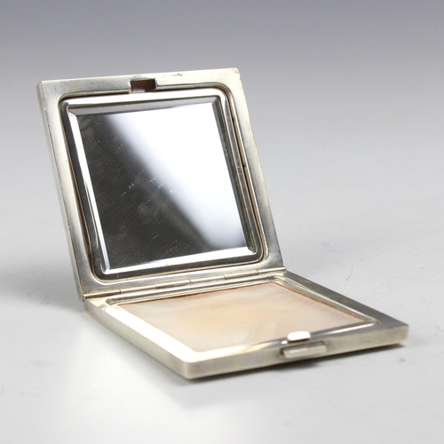 24 - An early 20th century Henin and Cie silver compact, the square hinged compact with engine turned and... 