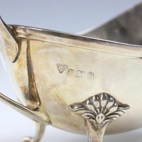 25 - A late 20th century silver sauce boat, Garrard & Co Ltd, Sheffield 1978, the florally capped handle ... 