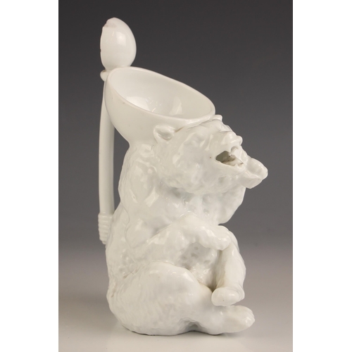 257 - An unusual continental porcelain white glazed bear form jug, 19th century, modelled as a seated roar... 