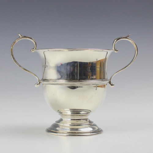 28 - A Victorian silver twin handled trophy, Henry Stratford, Sheffield 1897, the looped handles above fl... 