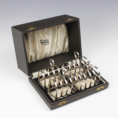 35 - A cased set of four George VI silver toast racks, Cooper Brothers & Sons Ltd, Sheffield 1940, retail... 