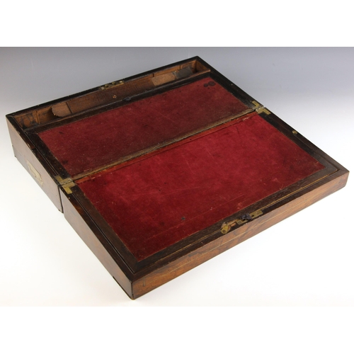 358 - A mid 19th century rosewood stationery box, inlaid with a brass cartouche and stringing, opening to ... 