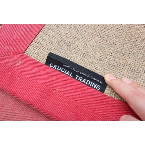 387 - A contemporary hessian backed runner, by Crucial Trading, the multi coloured stripes within a red bo... 