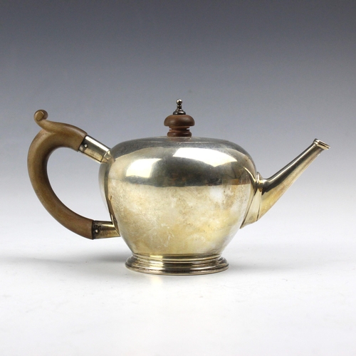 4 - A George V silver teapot, Lowe and Son, Chester 1936, the composite handle and finial above a plain ... 