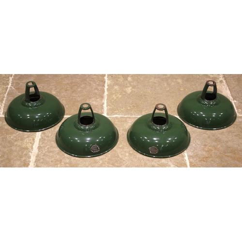 402 - A set of four green enamelled 'Coolicon' light shades, mid 20th century, of dish form with a white i... 