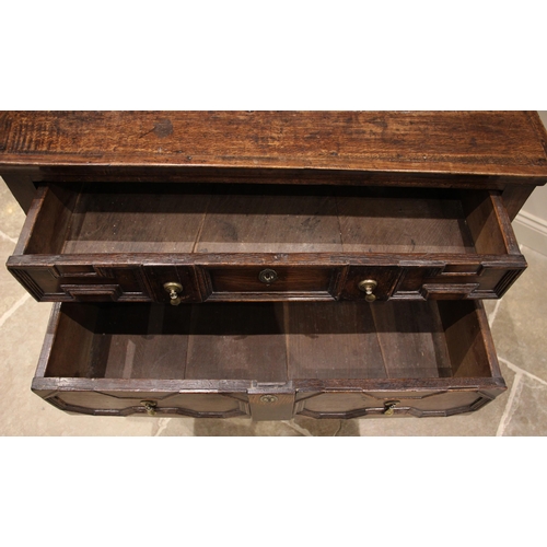 428 - A Jacobean geometric moulded oak chest of drawers, 17th century and later, formed with four long dra... 