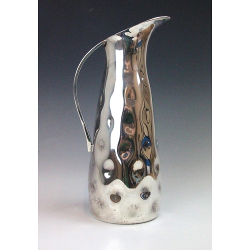 43 - A contemporary silver coloured jug, the planished tapered body with flared rim, 27.5cm high