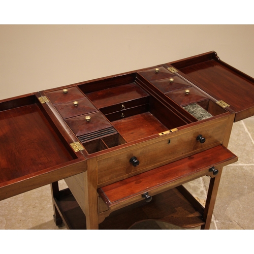 436 - A mahogany gentleman’s 'Beau Brummel' dressing table , 19th century, the flame mahogany twin hinged ... 