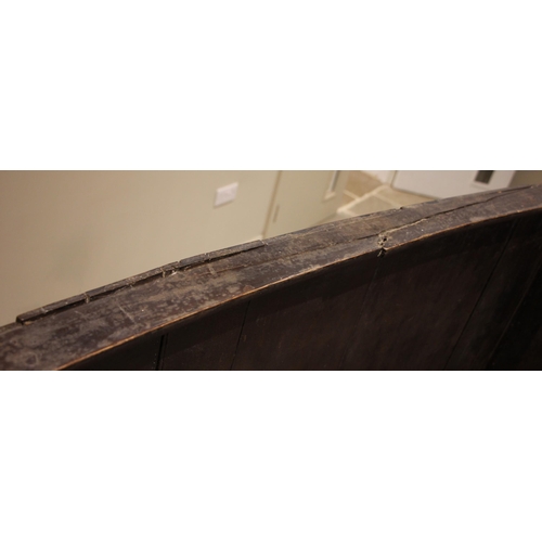 451 - A stained wood barrel back tavern settle, probably elm, late 18th/early 19th century, the curved ton... 