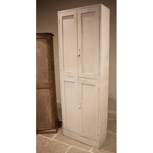 458 - A Victorian style painted pine cupboard, formed with two pairs of panelled cupboard doors opening to... 