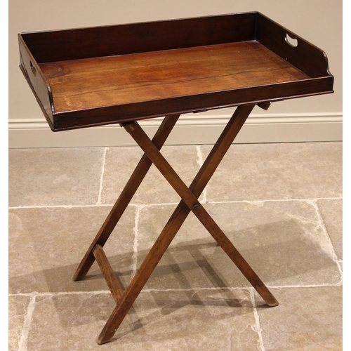 469 - A 19th century mahogany butler's tray and stand, the tray with a three quarter gallery and hand aper... 