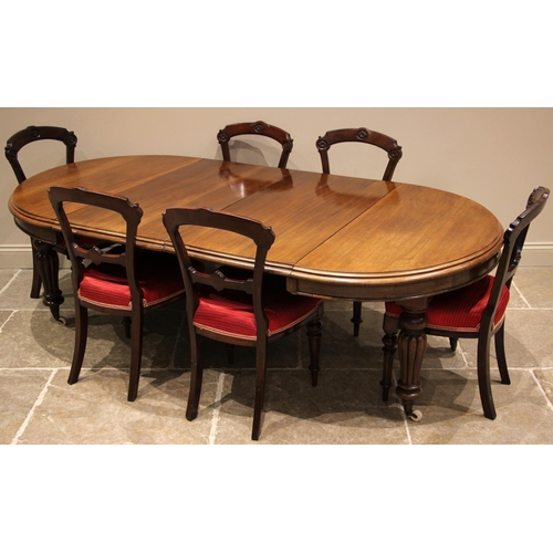 472 - A Victorian mahogany extending dining table, the circular moulded top upon lobed baluster legs and c... 