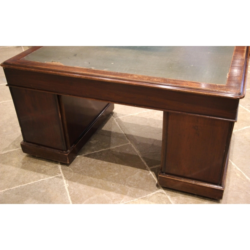 477 - A Victorian mahogany twin pedestal desk, the moulded rectangular top with rounded corners and inset ... 