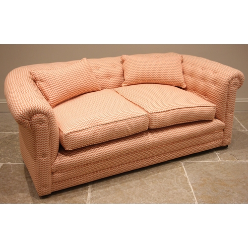 478 - A Chesterfield sofa, later re-covered in chevron banded fabric, of typical deep seated form with a b... 