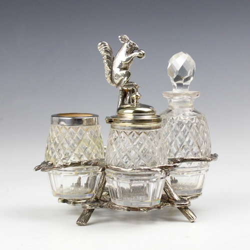 49 - A Mappin and Webb silver plated novelty cruet stand, the squirrel modelled finial above a branch des... 