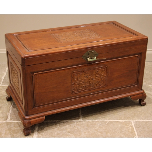 493 - A Chinese camphor wood storage chest, 20th century, with conforming carved stylised panels to the co... 