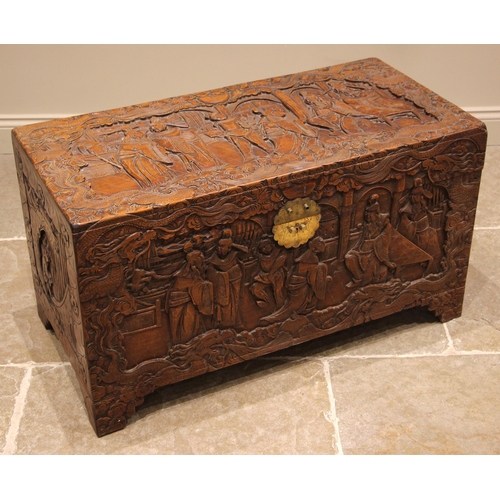 504 - A Chinese carved camphor wood chest, mid 20th century, the hinged cover carved in deep relief depict... 