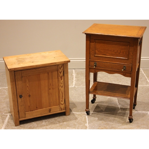 508 - A golden oak sewing/work table, early 20th century, the hinged cover opening to sliding compartmente... 