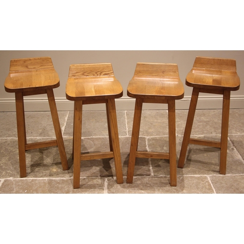 509 - A set of four contemporary light oak bar stools, each with a shaped seat extending to a raised back,... 